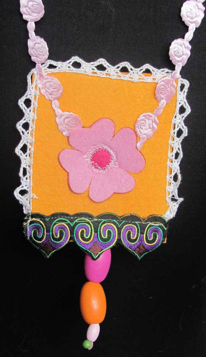large image of art item: accessory &ndash; felt necklace with pink flower on yellow background