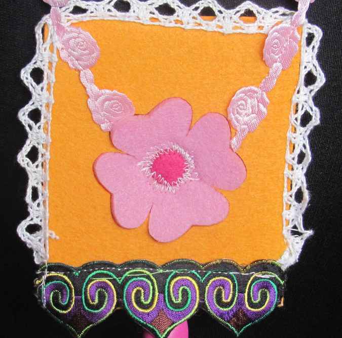 large image of art item: accessory &ndash; felt necklace with pink flower on yellow background