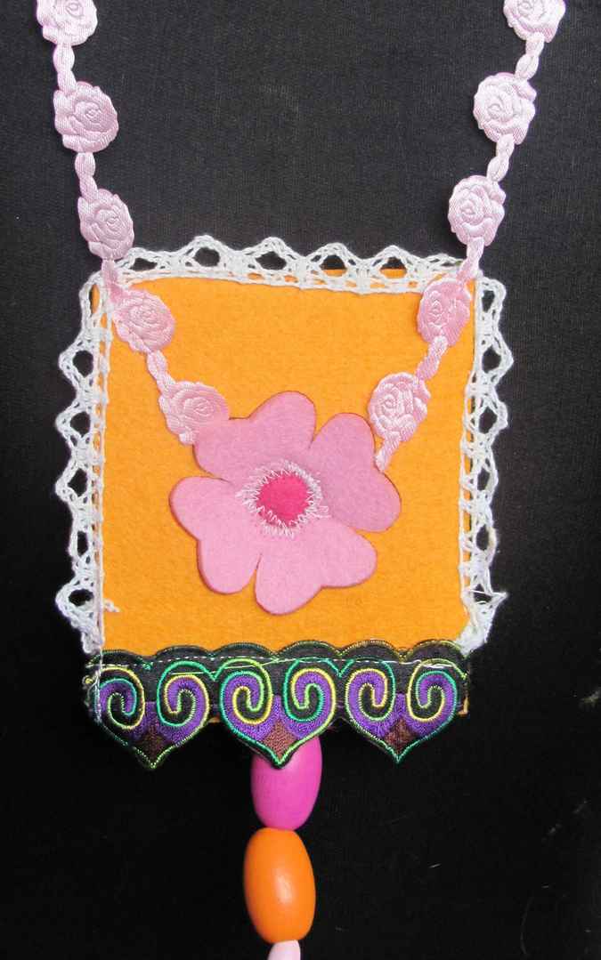 large image of art item: accessory &ndash; felt necklace with pink flower on yellow background