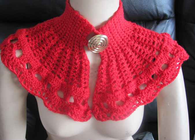 large image of art item: red crocheted capelet with golden button