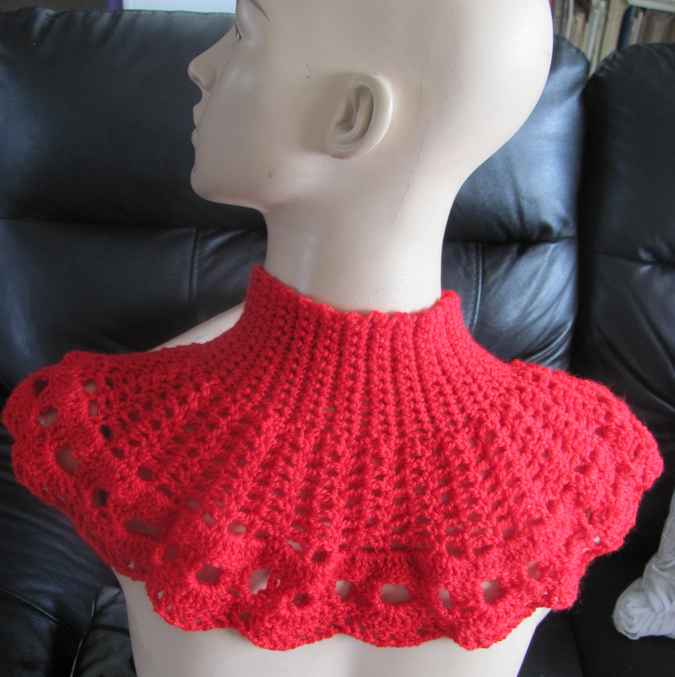 large image of art item: red crocheted capelet with golden button