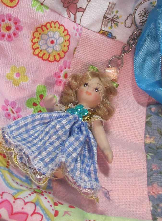 large image of art item: bag &ndash; doll and blue ribbon