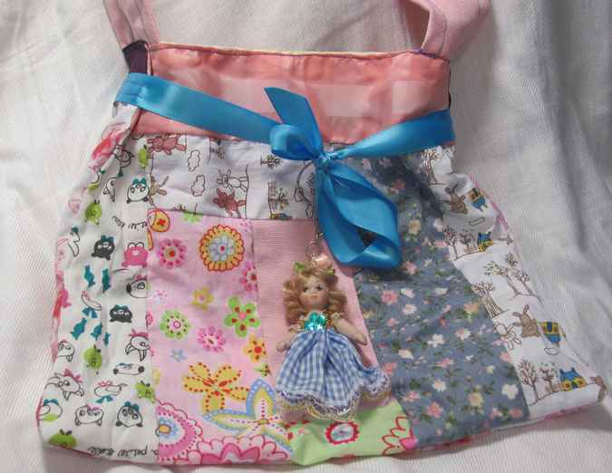 large image of art item: bag &ndash; doll and blue ribbon