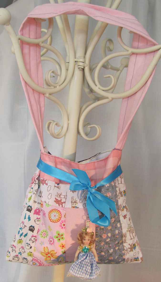 large image of art item: bag &ndash; doll and blue ribbon