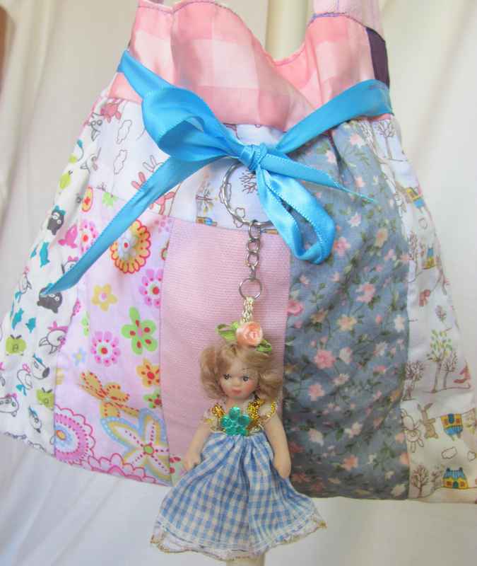 large image of art item: bag &ndash; doll and blue ribbon