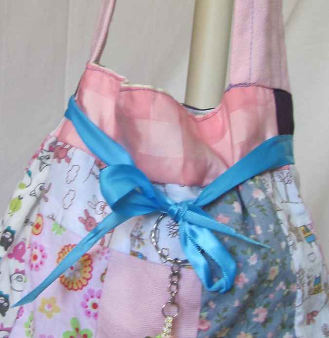 large image of art item: bag &ndash; doll and blue ribbon
