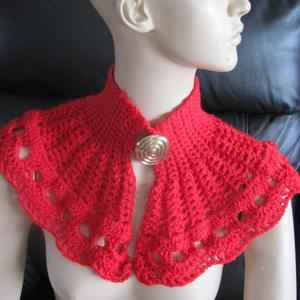 red crocheted capelet with golden button